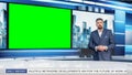 Talk Show TV Program: Handsome White Male Presenter Standing in Newsroom Studio, Uses Big Green