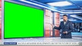 Talk Show TV Program: Handsome White Male Presenter Standing in Newsroom Studio, Uses Big Green