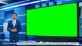 Talk Show TV Program: Handsome White Male Presenter Standing in Newsroom Studio, Uses Big Green