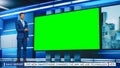 Talk Show TV Program: Handsome White Male Presenter Standing in Newsroom Studio, Uses Big Green