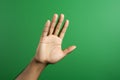 Talk to the Hand hand gesture on green background Royalty Free Stock Photo