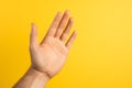 Talk to the Hand hand gesture on yellow background Royalty Free Stock Photo