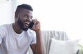 Talkative african american man talking on phone with friends Royalty Free Stock Photo