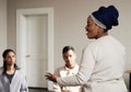 Talking, black woman and group of people in therapy with understanding, sharing feelings and psychology session. Mental Royalty Free Stock Photo