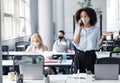 Talking with client in workspace and return after quarantine. Employees work in office with laptops and antiseptics Royalty Free Stock Photo