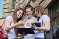 Talking group of student girls, teenage girls college students near brick building Royalty Free Stock Photo