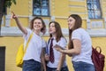 Talking group of student girls, teenage girls college students near brick building Royalty Free Stock Photo