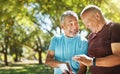 Talking, men and a phone in a park for fitness, training results and conversation about an app. Happy, communication and Royalty Free Stock Photo