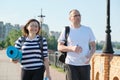 Talking middle-aged man and woman, couple walking along park road Royalty Free Stock Photo