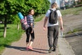 Talking middle-aged man and woman, couple walking along park road Royalty Free Stock Photo