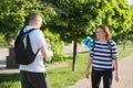 Talking middle-aged man and woman, couple walking along park road Royalty Free Stock Photo