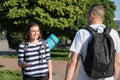 Talking middle-aged man and woman, couple walking along park road Royalty Free Stock Photo