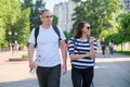 Talking middle-aged man and woman, couple walking along park road Royalty Free Stock Photo
