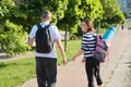 Talking middle-aged man and woman, couple walking along park road Royalty Free Stock Photo