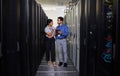 Talking, people and technician in server room with tablet for cybersecurity, update or team problem solving in data or Royalty Free Stock Photo