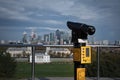 Talking telescope on an observation deck in Greenwich Royal Park with a view on Queen`s house and London city