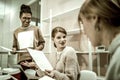 Red-haired student wearing necklace talking to groupmate Royalty Free Stock Photo