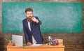 Talking to students or pupils. Teacher bearded man tell interesting story. Teacher charismatic hipster stand near table