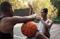 Talking about trick shots. two sporty young men chatting to each other on a basketball court. Royalty Free Stock Photo