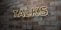 TALKS - Glowing Neon Sign on stonework wall - 3D rendered royalty free stock illustration