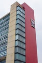 Tall administrative building from Mexican college under cloudy sky