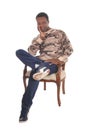 Tall African American man sitting in armchair Royalty Free Stock Photo