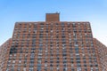 A tall apartment building complex in Harlem, with visible fire damage on the left side, New York City, NY, USA Royalty Free Stock Photo