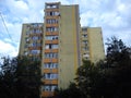 Tall apartment building of the late socialism era. Yellow facade, balconies and loggias, residential condition. Royalty Free Stock Photo