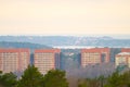 Tall apartment buildings by a forest..