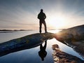 Tall backpacker watch clear sunny daybreak over sea. Hiker Hiker enjoy breathtaking sunrise Royalty Free Stock Photo