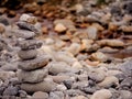 Tall balance stone tower against organic nature background. Concept patience at reaching your target Royalty Free Stock Photo