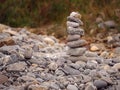 Tall balance stone tower against organic nature background. Concept patience at reaching your target Royalty Free Stock Photo