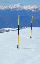 black and yellow stakes stuck in the white snow to delimit the ravine near the road in the mountains in winter Royalty Free Stock Photo