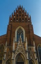 a tall brick church with large arched windows and an ornate steeple