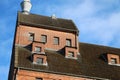 Tall brick house roof on a clear blue sky background Royalty Free Stock Photo