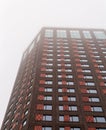 tall brick office building in dense fog.. Royalty Free Stock Photo