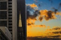 A tall building that goes into sunset sky and rainy clouds the sky. Royalty Free Stock Photo