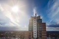 A tall building made of glass. Blue sky and bright sun Royalty Free Stock Photo