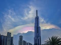 A tall building with a rainbow on top Royalty Free Stock Photo