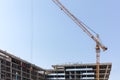 Building under construction with yellow tower cranes against blu Royalty Free Stock Photo