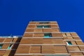 A tall building with a wooden facade to be more ecological and sustainable in its construction and maintenance, seen from below Royalty Free Stock Photo