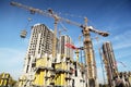 Tall buildings under construction and cranes Royalty Free Stock Photo