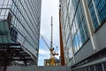 The tall business skyscrapers and the construction crane i Royalty Free Stock Photo