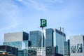 The tall business skyscrapers and the parking sign Royalty Free Stock Photo