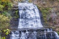 Cascading waterfall in levels running through rocky forested lan Royalty Free Stock Photo