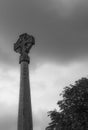 Detailed view of a very tall monument and crucifix seen in an English cemetery.