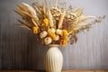 a tall ceramic vase filled with dry field flowers Royalty Free Stock Photo