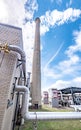 Tall chimney at boiler building at industrial plant Royalty Free Stock Photo