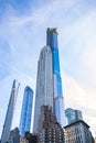 Tall city skyscrapers towering over blue sky and clouds