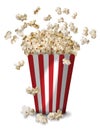 A tall classic box of theater popcorn popping up and scattered around on white background. Royalty Free Stock Photo